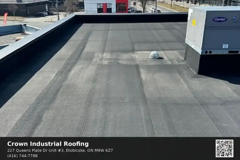 Commercial flat roof replacement cost in Toronto warehouse with crew installing 2-ply SBS modified bitumen membrane